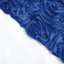 A close up of a royal blue satin fabric with 3D rosette roses
