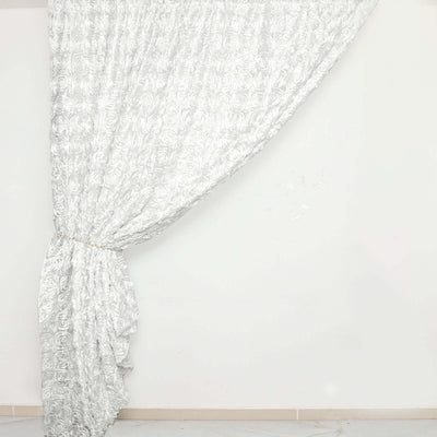 Elegant white rose-patterned curtain draped gracefully.