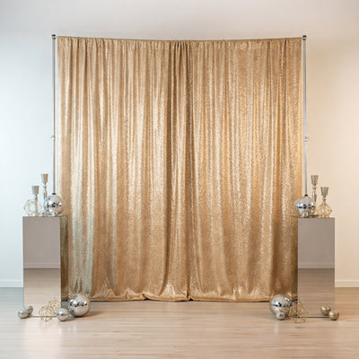 Gold sequin backdrop with decorative mirrors and ornaments for events or photo shoots.
