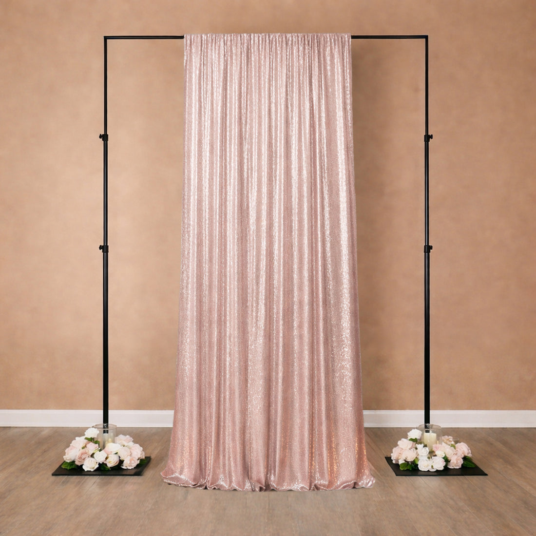 Rose gold sequin backdrop draped elegantly on a black frame with floral accents.