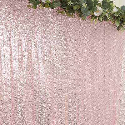 Pink sequined backdrop with floral accents for events and photography.