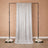 Sparkling silver backdrop draped for events with floral arrangements at the base.