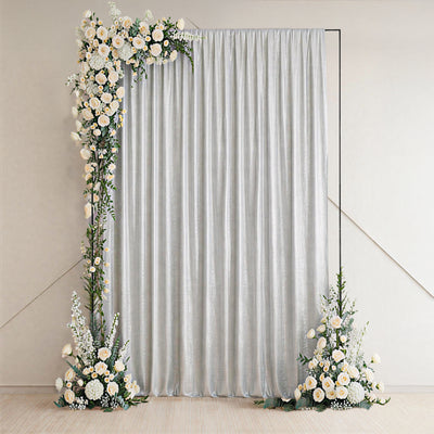Decorative silver curtain with floral arrangements on either side