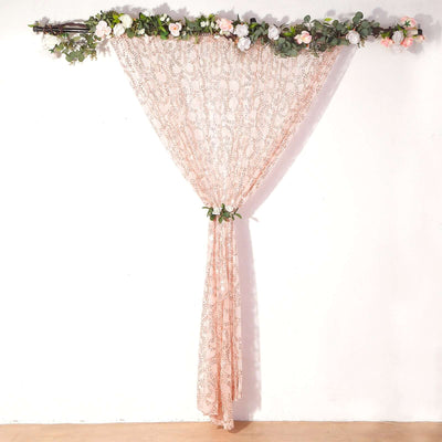 Floral lace curtain hanging decoratively with greenery accents.