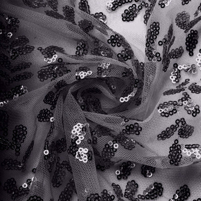 Black sequined tulle fabric with shimmering sequins on a soft background.
