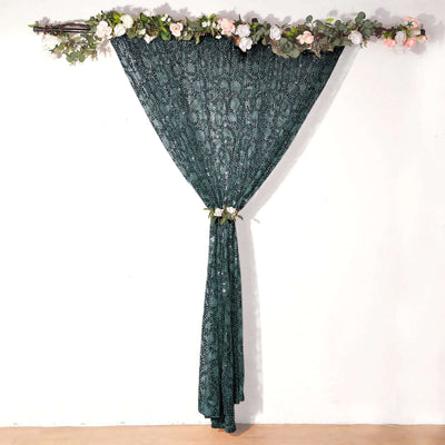 Dark green lace curtain with floral decoration, hanging elegantly.