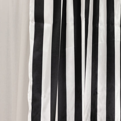 Black and white striped curtain fabric hanging elegantly.