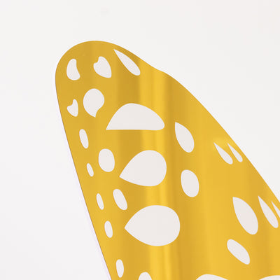 Yellow decorative cutout with unique shapes on a white background