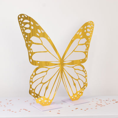 Golden butterfly sculpture on a table with confetti