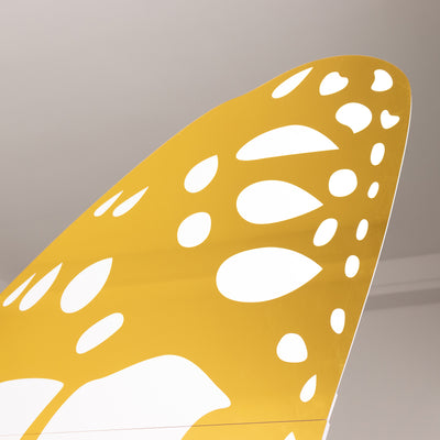 Yellow butterfly wing cutout on a plain background.