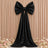 Black satin bow backdrop decor with draped fabric and floral accents