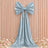 Elegant silver satin bow drape on peach backdrop with floral decor