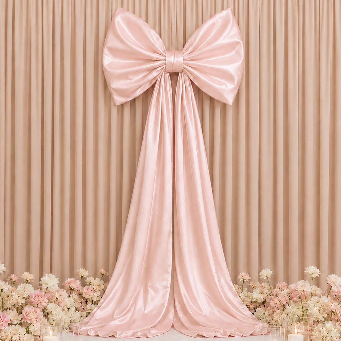 Blush pink satin bow backdrop with floral wedding decor