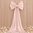 Blush pink satin bow backdrop with floral wedding decor
