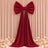 Red velvet bow and draped curtain backdrop with pastel flowers and candles