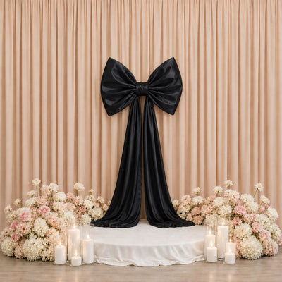Elegant black bow wedding backdrop with pastel flowers and candles