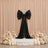 Elegant black bow wedding backdrop with pastel flowers and candles