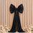 Black satin bow drape on beige pleated backdrop with flowers
