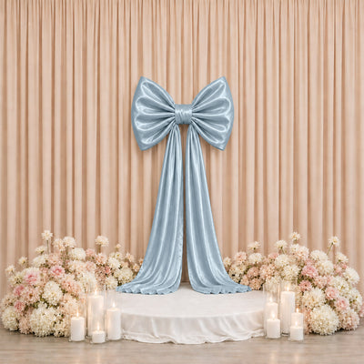Elegant pastel blue bow stage backdrop with flowers and candles