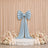 Elegant pastel blue bow stage backdrop with flowers and candles