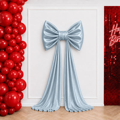 Blue satin bow backdrop with red balloon wall and sequin Happy Birthday sign