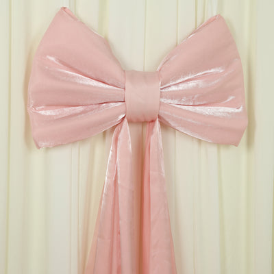 Large pink satin bow decoration on a soft cream backdrop.