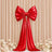 Red satin bow backdrop with long ribbon and floral arrangement