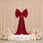 Elegant red velvet bow backdrop with flowers and candles for wedding decor