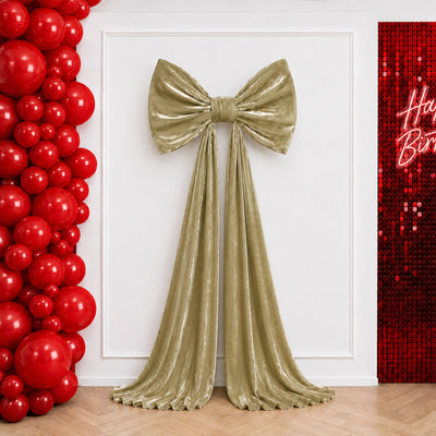 Gold velvet bow backdrop with red balloon arch and sequin birthday wall