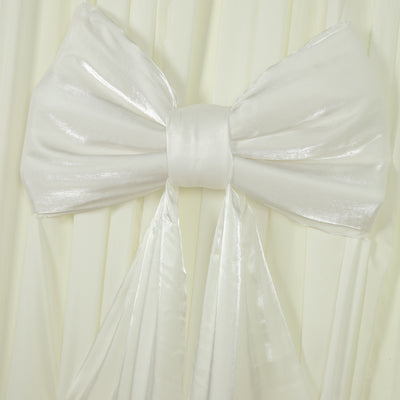 White satin bow on a draped fabric background.