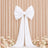 White bow wedding backdrop with flowing drapes and floral accents