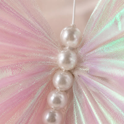Pearl bead bracelet with iridescent pink butterfly wings close-up