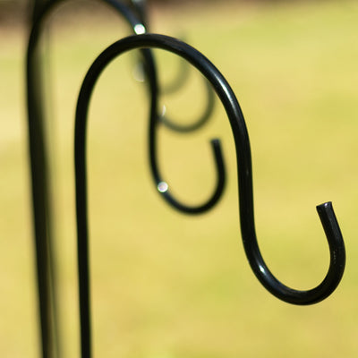 Black metal garden hook with elegant curved design.
