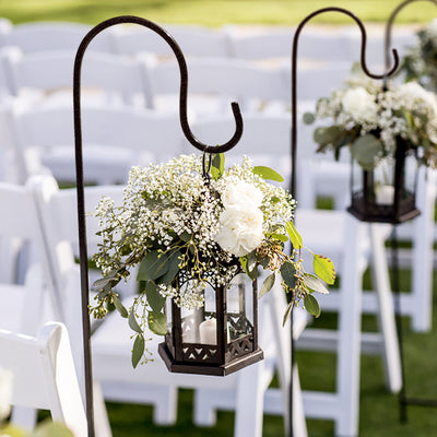 Hanging lantern with flowers for outdoor wedding decor.