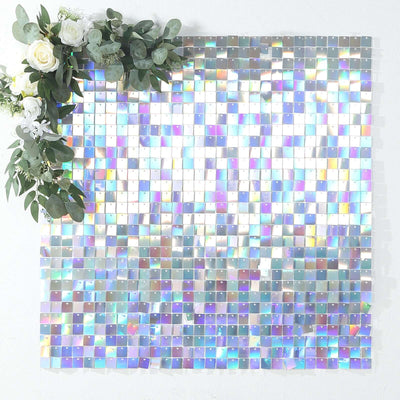 Iridescent square mosaic tile backdrop with greenery accents.