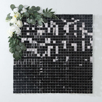 Black and white mosaic tile wall art with floral accents.
