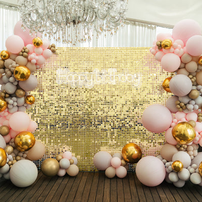 Birthday party backdrop with colorful balloons and a gold sequin wall.