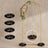 Gold wedding arch with floral accents and four black base cushions