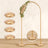 Gold circular cushions with floral arch backdrop for event decor.