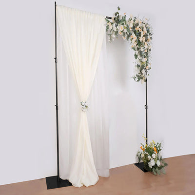 Wedding backdrop with draped fabric and floral arrangement