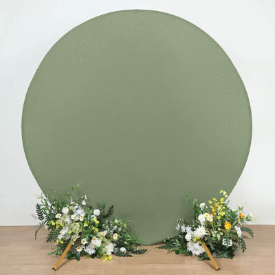 Green backdrop with floral arrangements on either side.