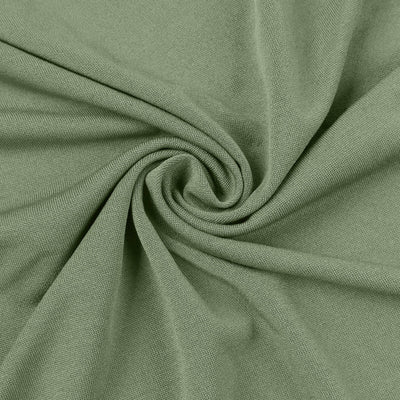 Textured green fabric swirl close-up showcasing its softness and drape.
