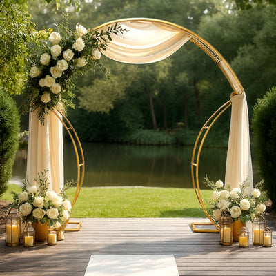 Elegant wedding arch adorned with white roses and draped fabric by a serene lake.