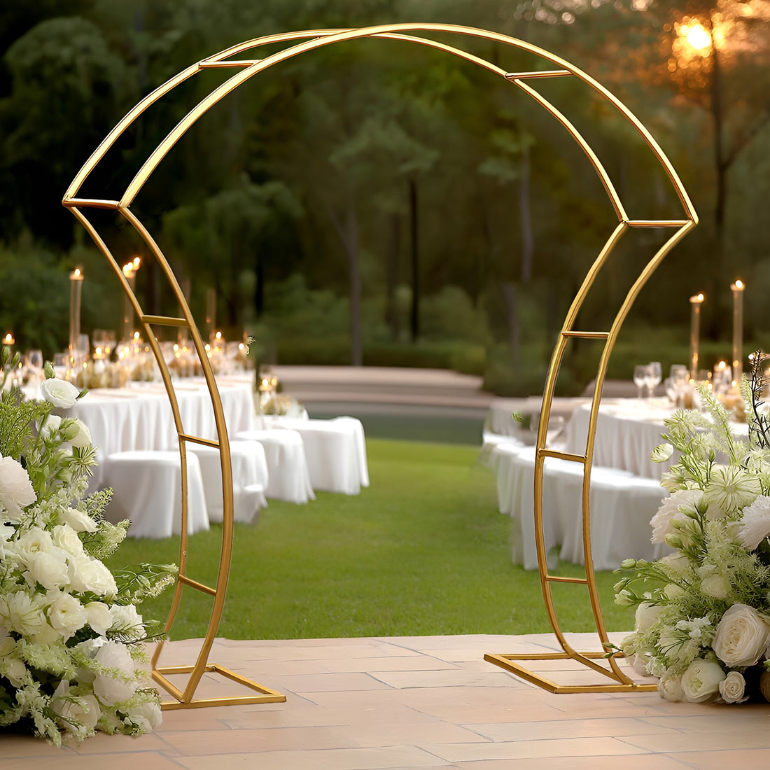 Elegant gold wedding arch with floral arrangements, set in a beautiful outdoor venue.
