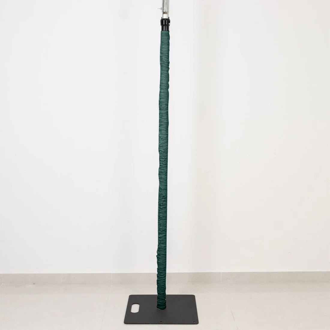 Green adjustable stand pole with weighted base on white background