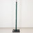 Green adjustable stand pole with weighted base on white background