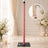 Pink pole dance pole with weighted base in elegant floral studio setup