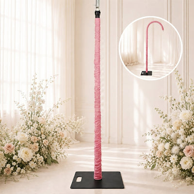 Pink wrapped curved flower stand on black base for wedding floral display