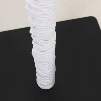 White ruched fabric on a black base, showcasing texture and design.