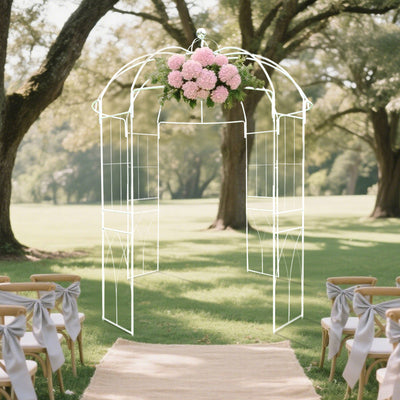 Wedding arch with pink flowers in a beautiful outdoor setting.